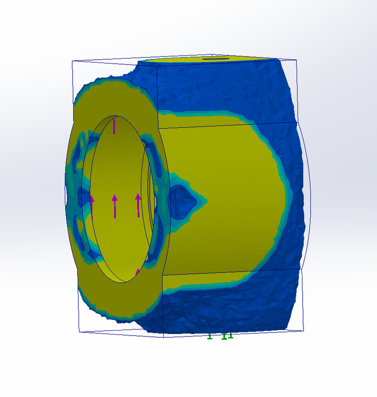 SolidWorks Simulation stress plot of a cylindrical housing with a bore; load arrows inside the bore and fixtures at the base; no legend shown