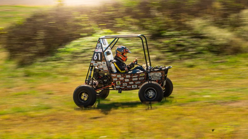 Orange ONU Baja SAE car number 49 testing on a dirt course