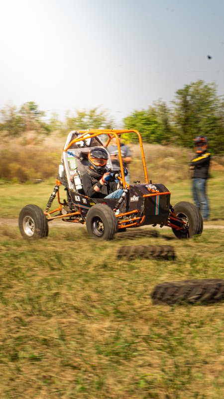 Orange ONU Baja SAE car number 49 testing on a dirt course