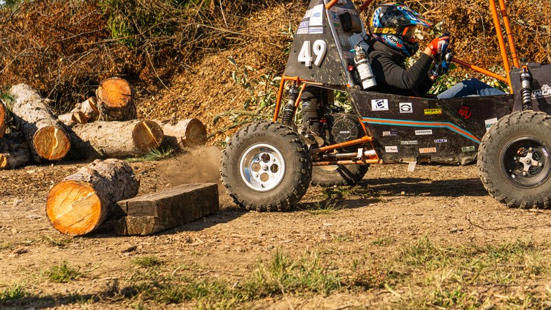 Orange ONU Baja SAE car number 49 testing on a dirt course