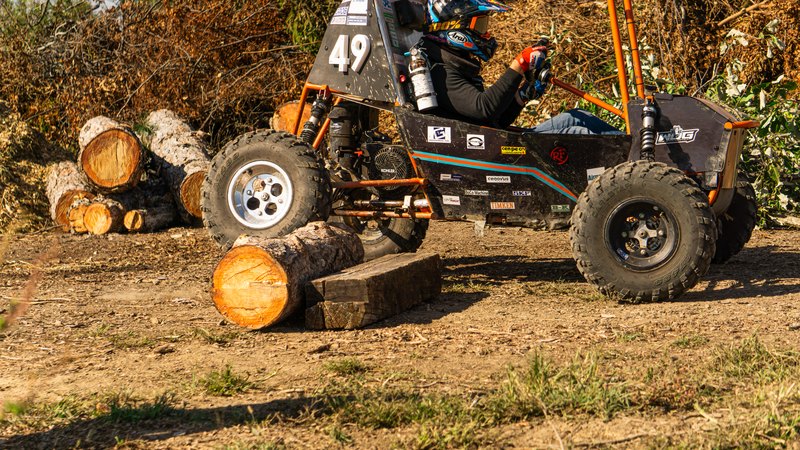 Orange ONU Baja SAE car number 49 testing on a dirt course