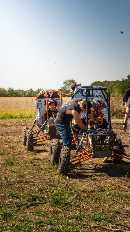 Orange ONU Baja SAE car number 49 testing on a dirt course