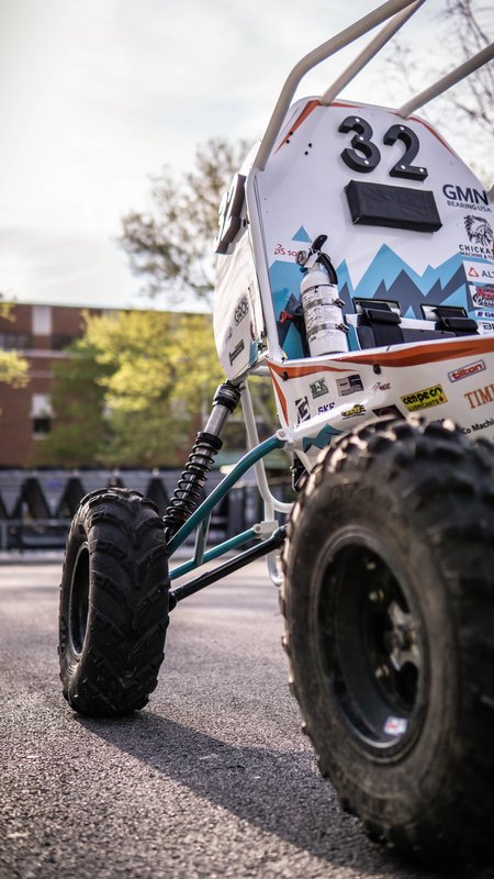 Low wide-angle view of Baja car number 32: front wheel and number panel