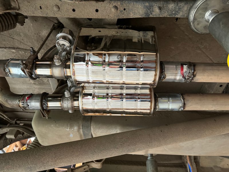 Polished mufflers installed under the truck, May 16, 2024