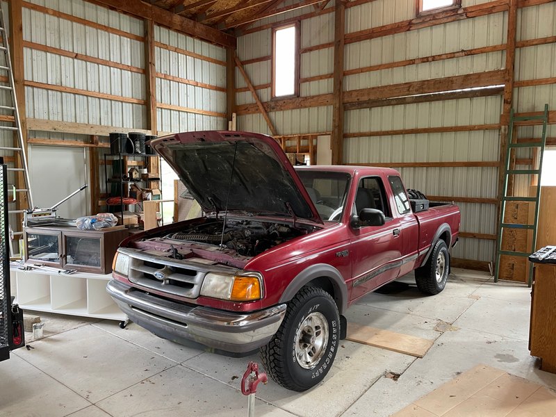 Front 3/4 view in the shop, hood up, Apr 10, 2021